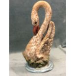 A heavy Victorian painted cast iron doorstop, cast as a swan on naturalistic plinth. (14.75in)