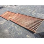 A rectangular pierced metal grid with grill bars in angleiron frame - 62in x 28in; and another