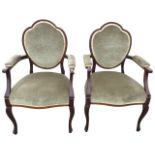 A pair of mahogany boxwood strung open armchairs, the backs with scalloped oval upholstered