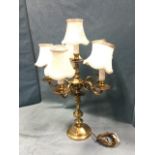 A brass candelabra type tablelamp with hexagonal column supporting five scrolled branches with