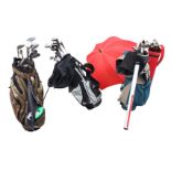 Four bags of contemporary golf clubs - Dunlop, Letters, umbrellas, Wilson, Regal, Turbopower,