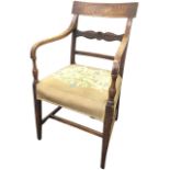 A nineteenth century country elm elbow chair, having rectangular back rail above a leaf carved