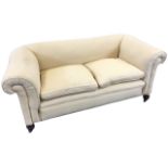 A Victorian upholstered two-seater sofa with padded back and arms above a sprung seat, raised on