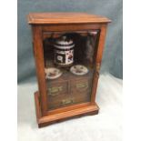 A late Victorian locking oak mixing cabinet with moulded top above a bevelled glass door enclosing