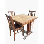 An oak draw-leaf dining table with panelled extending top on rectangular supports above splayed feet