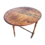 A Victorian burr walnut sutherland table, the oval moulded top having two drop-leaves supported on