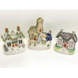 A Victorian Staffordshire pastel burner modelled as a cottage with applied boccage; another