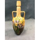 An art nouveau Doulton Lambeth vase with angled handles and tubular neck above an egg shaped body,