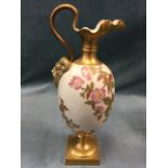 A Royal Worcester blush ivory pitcher, the egg-shaped body decorated with gilded flowers on peach