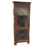 A large nineteenth century mahogany corner cupboard with moulded cornice above two astragal glazed
