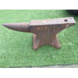 A cast iron anvil with pierced rectangular working platform and tapering end, raised on waisted