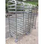 A pair of rectangular aluminium trolleys designed to take trays with square rounded frames on