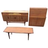 An E Gomme Ltd 60s teak sideboard with three frieze drawers above cupboards, all mounted with