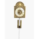 A wallclock with embossed scrolled brass arched face and silvered chapter ring, with tubular weights