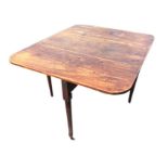 An early nineteenth century mahogany drop-leaf dining table, the rectangular top with rule-jointed