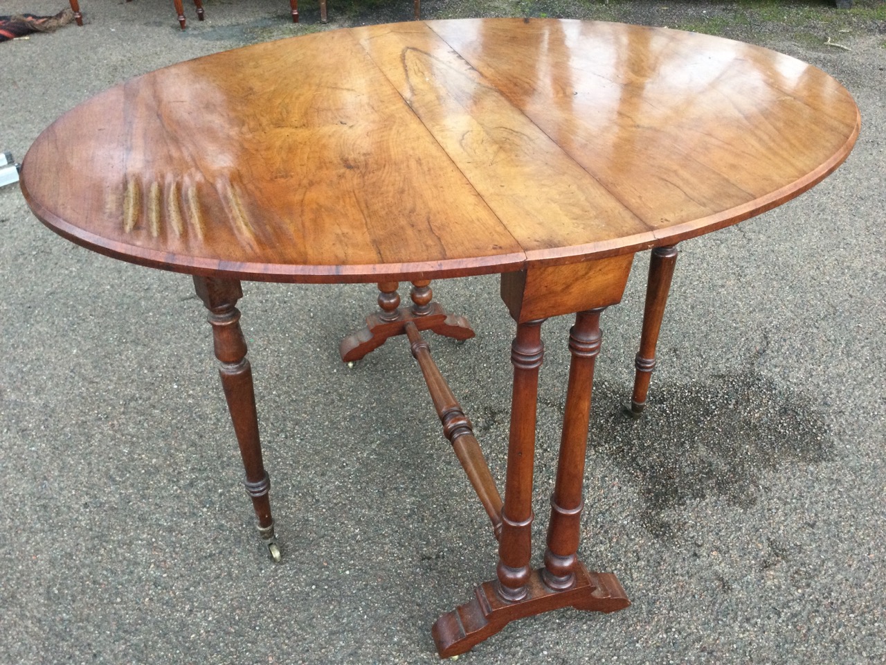 A Victorian walnut sutherland table with two rounded drop leaves forming an oval moulded top, - Bild 3 aus 3