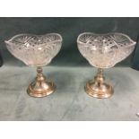 A pair of Elkington silver plated fruitbowls on stands, the glass vessels with serrated rims on