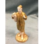 A Royal Worcester water carrier figurine with moustachioed figure in gilt garments holding a pitcher