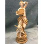 An Austrian porcelain figurine of a draped lady with open box above a winged cherub, raised on