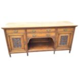 A late Victorian carved oak sideboard with rectangular moulded top above a central section with