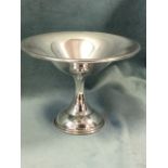 A silver bon-bon dish, the bowl with rolled rim on waisted column above a circular moulded