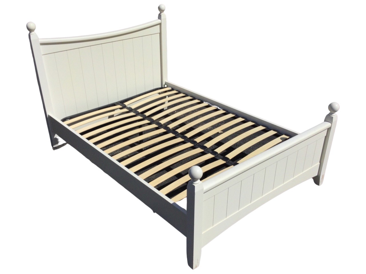 A contemporary painted double bed with boarded headboard & tailboard beneath banister style rails,