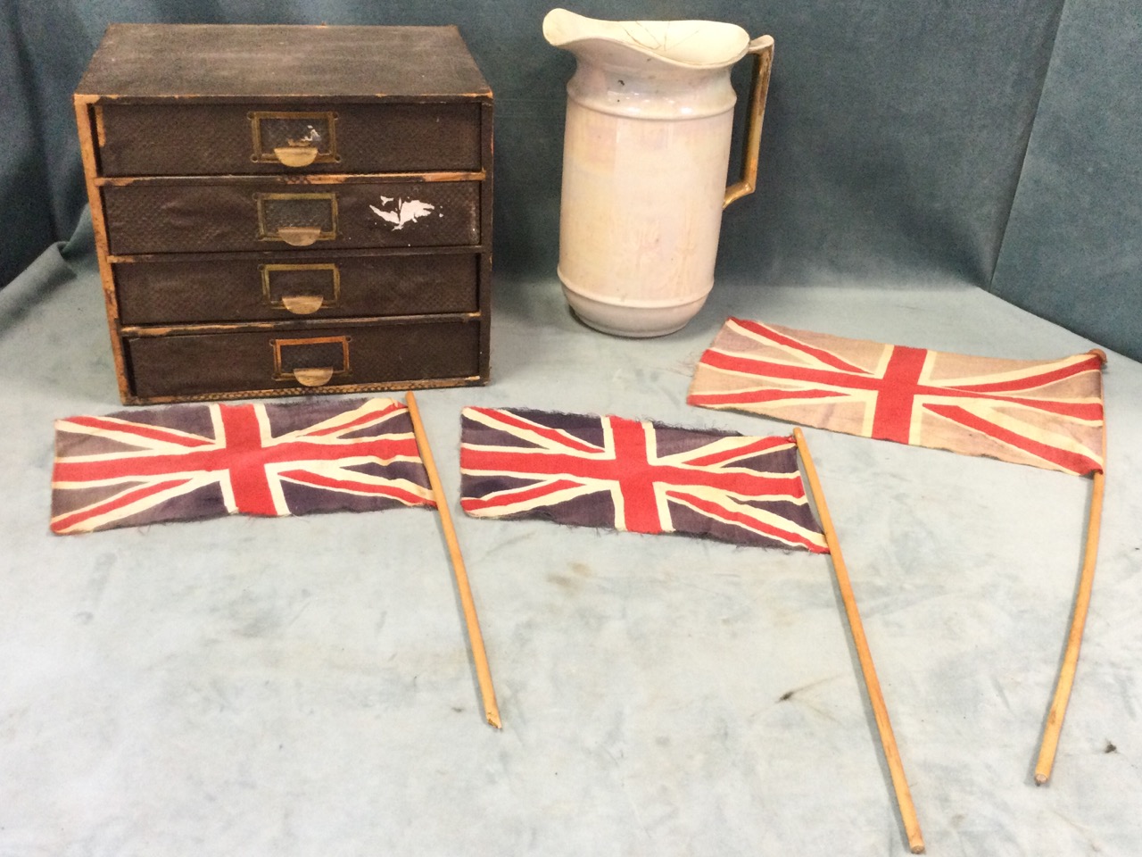 A four-drawer stationary cabinet with brass pulls/label holders; an opaline lustre glazed pitcher