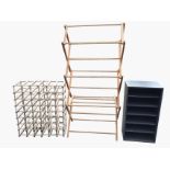 A large collapsible drying rack with twelve rails; a metal cabinet with five open shelves/