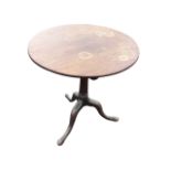 A Georgian mahogany tip-top occasional table, the circular top on tapering turned canon barrel