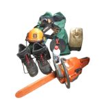A chainsaw outfit with a Husqvarna 353 saw, helmet, Stihl protective trousers and ear defenders,