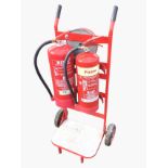 A portable fire station on sack barrow type stand, with alarm bell and two fire extinguishers -