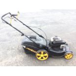 A McCulloch self-propelled rotary mower with a Briggs & Stratton engine, complete with instruction