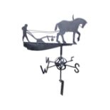 A wrought iron weather vane, the arrow in the form of a fretwork ploughman with horse, above a globe