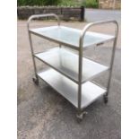A rectangular stainless steel trolley with three trays on square column supports on casters, the