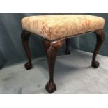 A nineteenth century mahogany stool with rectangular upholstered studded seat, raised on tapering