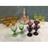 A floral enamelled suite of glass with decanter & stopper, tray and five glasses; a set of four
