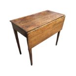 A nineteenth century country oak side table, the top with drop-leaf and gate, raised on square