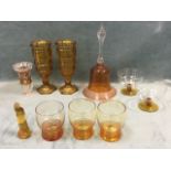 Miscellaneous amber glass including a pair of tall ribbed vases, tumblers, a large bell, a girl