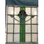 An art nouveau leaded stained glass panel with central floral pillar. (25in x 29.5in)