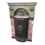 A continental stove cabinet with rouge marble top above a hammered brass grill platform enclosed