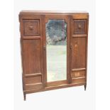 A late C20th oak wardrobe with Chapman Siesta Newcastle label, having caddy top above a central