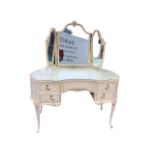 A painted Louis Quaize style dressing table, the mirror with hinged wings, above a serpentine