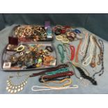 A large quantity of costume jewellery - beads, bangles, some cased & boxed, faux pearls, wood,