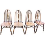 A set of four reproduction elm chairs by Glenister of High Wycombe, the high arched backs with