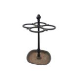 A cast iron stickstand, the four conjoined hoops supported on a central knobbed column above a
