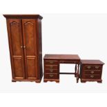 A reproduction mahogany bedroom suite with dwarf chest of drawers, panelled door wardrobe and