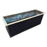 A rectangular metal trough with brass lining and flat rim. (34in)
