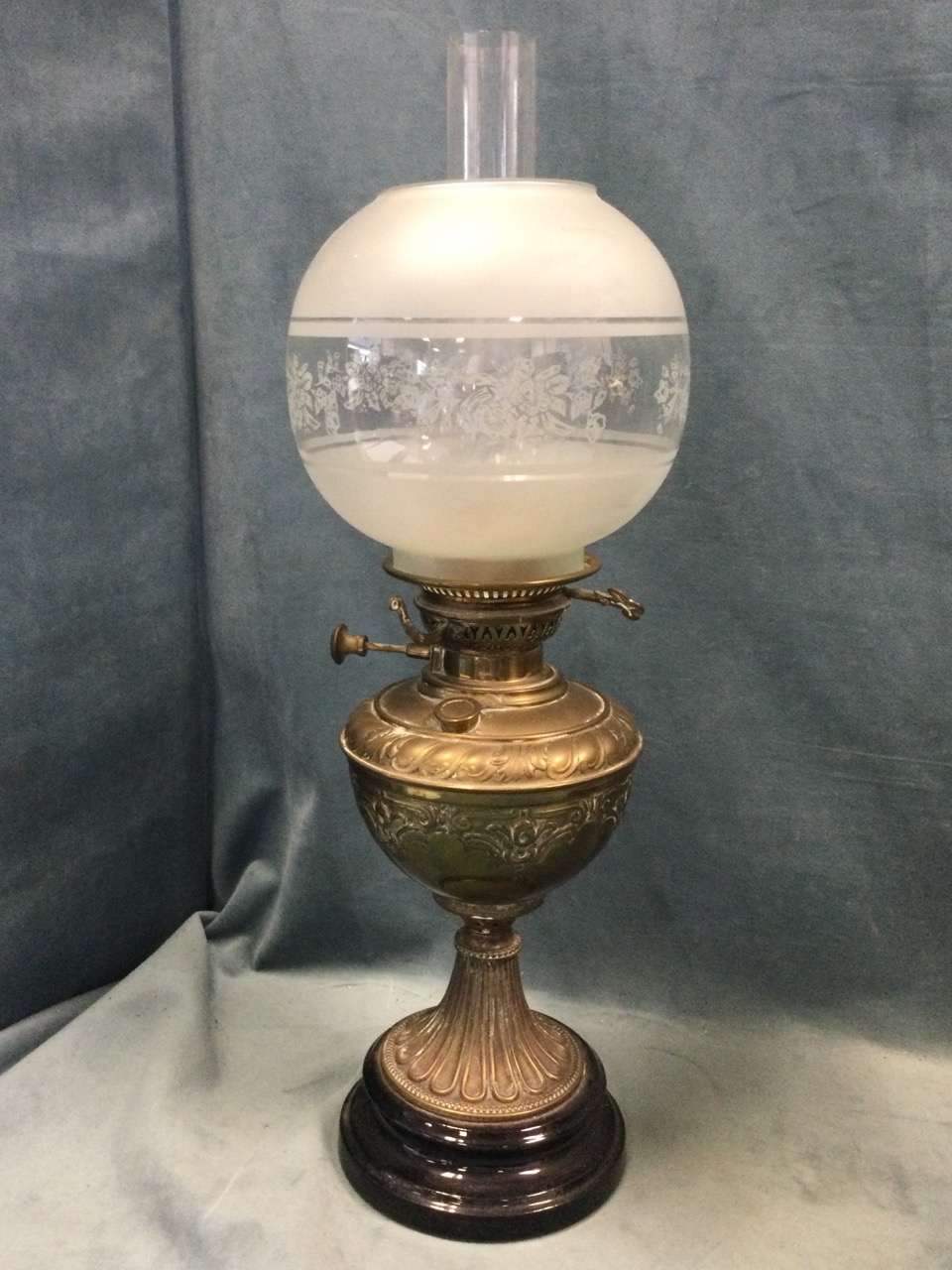 A Victorian brass oil lamp with embossed reservoir on fluted base mounted on glazed stand, fitted - Image 2 of 3