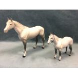 A graduated pair of Beswick dappled grey horses. (11in & 8in) (2)