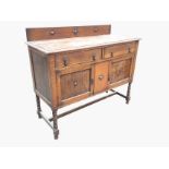 A George VI oak sideboard with applied roundel decoration, the rectangular moulded top with